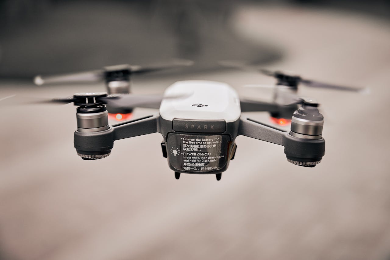 hero-contact Close-up of a modern drone flying outdoors, showcasing advanced technology and propellers.