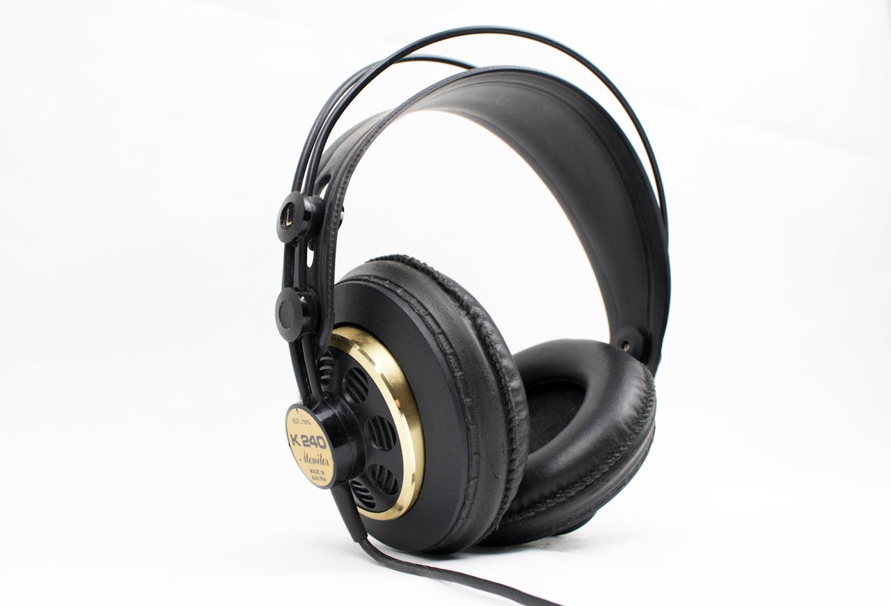 services-04 High-quality black and gold studio headphones with thick padding on a white background, ideal for music professionals.