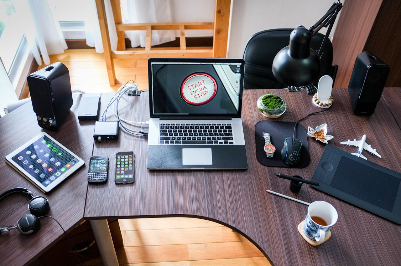 about-02 A contemporary office desk setup with laptops, gadgets, and accessories, creating a tech-savvy workplace.